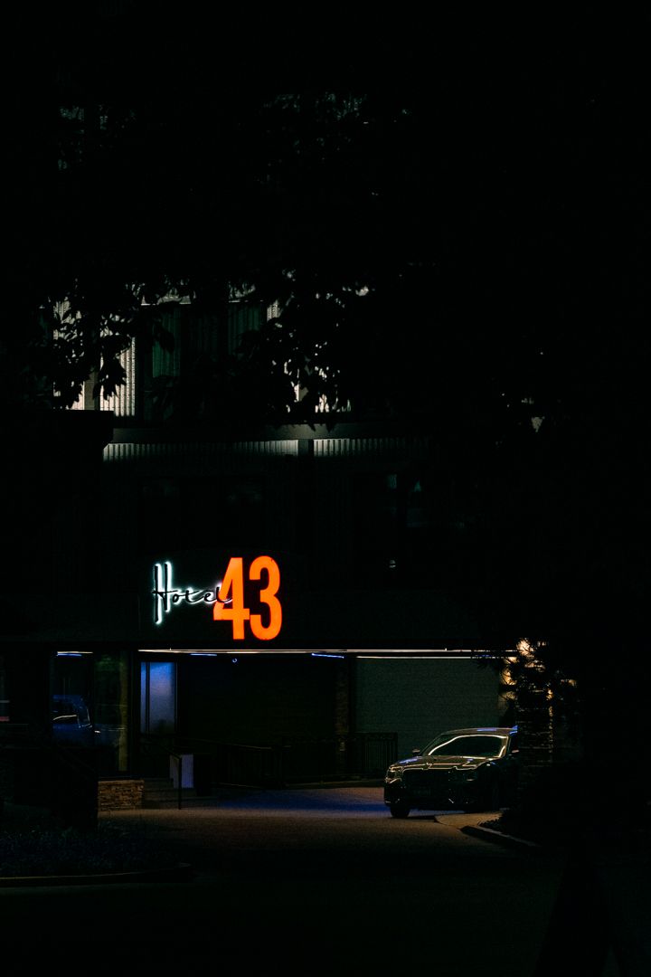 A Chrysler 300 sedan parked near the valet entrance of Hotel 43 in downtown Boise Idaho, photographed before dawn