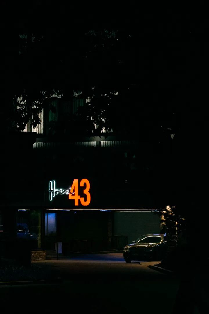 A Chrysler 300 sedan parked near the valet entrance of Hotel 43 in downtown Boise Idaho, photographed before dawn